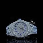 AP Royal Oak Iced Out Watch with White Dial and Blue Arabic Numerals, showcasing intricate diamond details and luxury design.