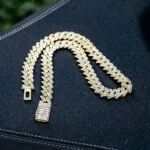 Moissanite Cuban Link Chain in 14K Yellow Gold featuring a bold 14mm width and round-cut stones.